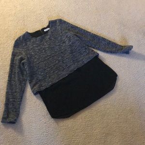 Gray sweater with black top connected underneath.
